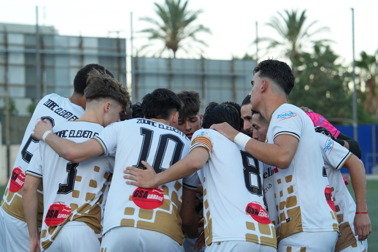 Zodiac Eleven players in a pre-match huddle