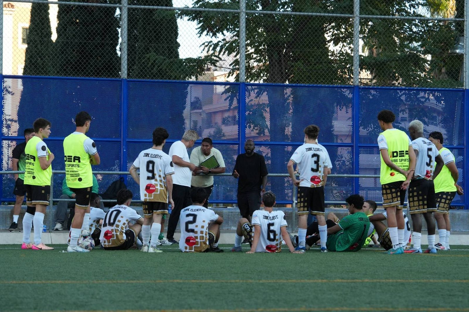 Zodiac Eleven coach giving instructions to the squad pitchside
