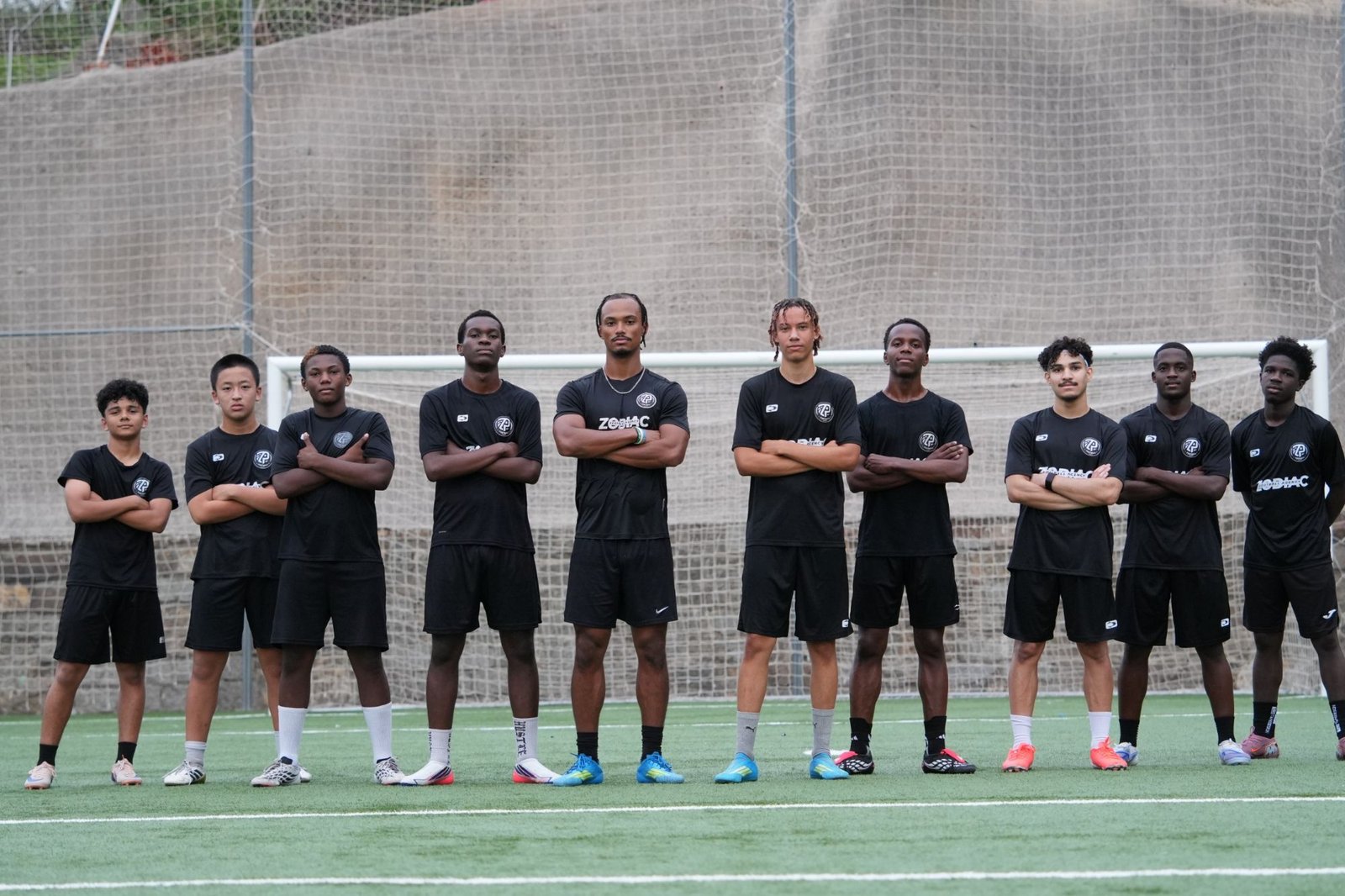 Zodiac Pro squad lined up on the training pitch in Barcelona