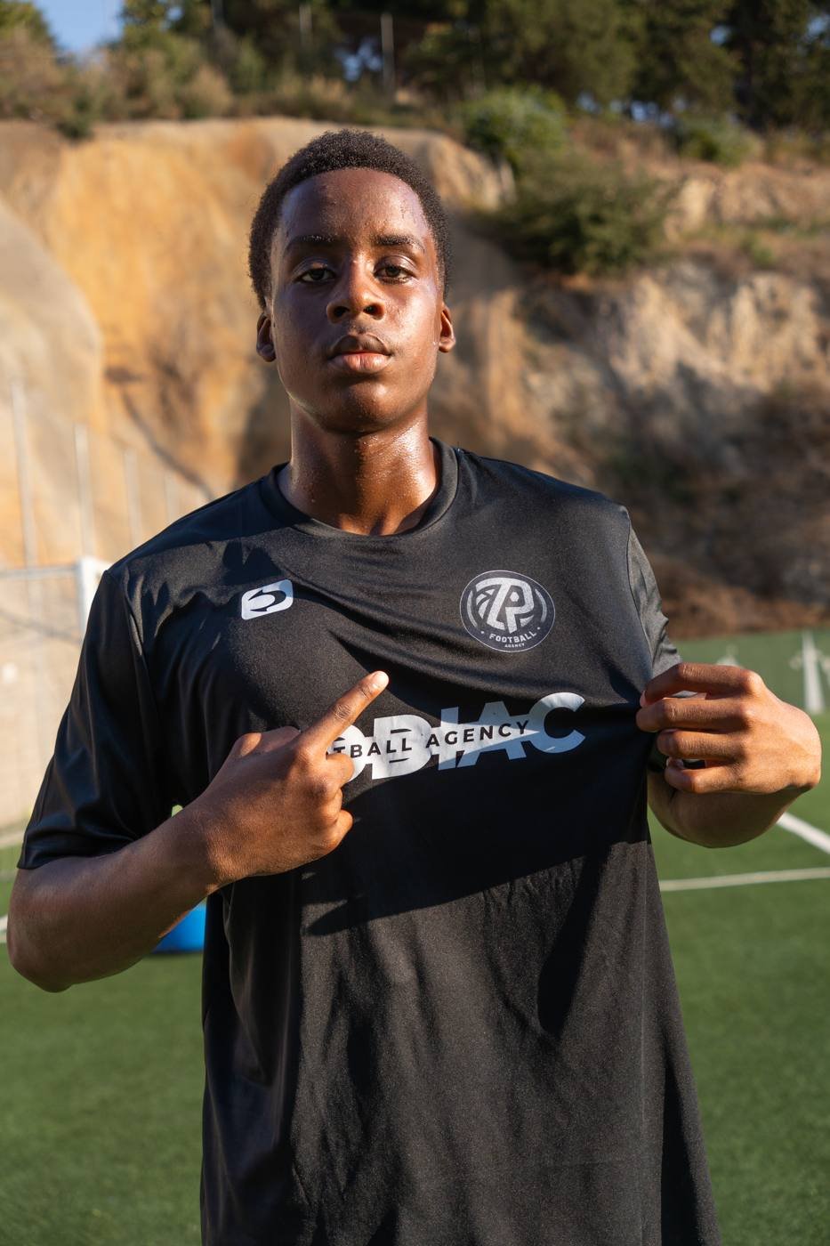 Zodiac Pro player pointing to the club badge